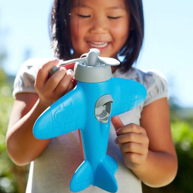 Child Playing with the Blue Airplane Toy
