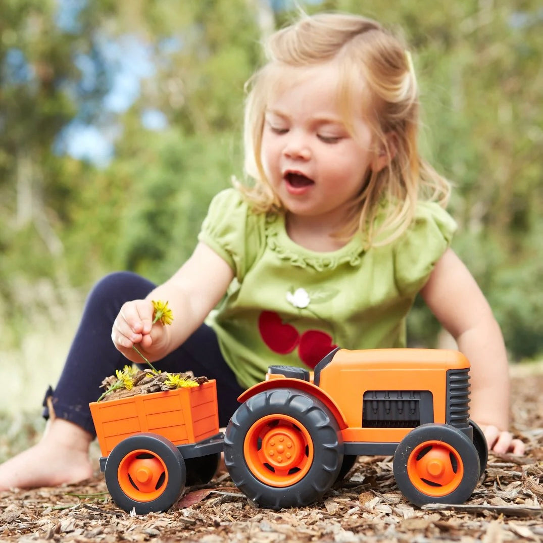 Child Playing with the Green Toys Orange Tractor Toy - Made in USA