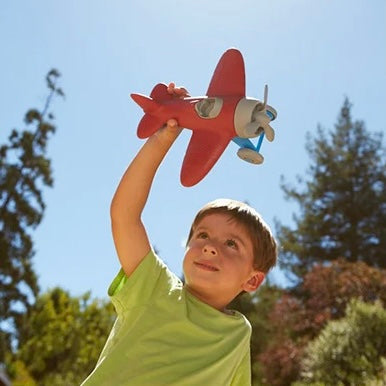 Child Playing with the Red Airplane Toy
