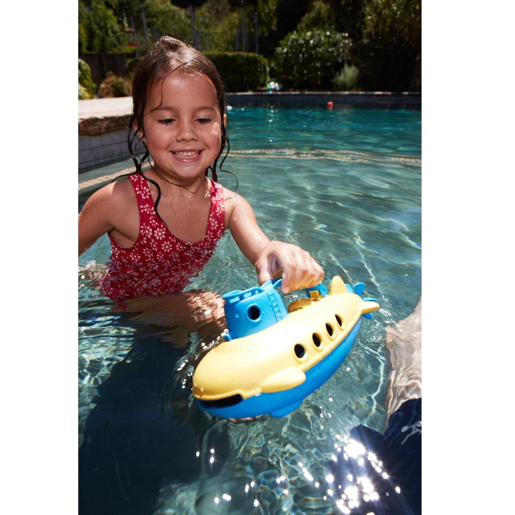 Child playing with the submarine water toy