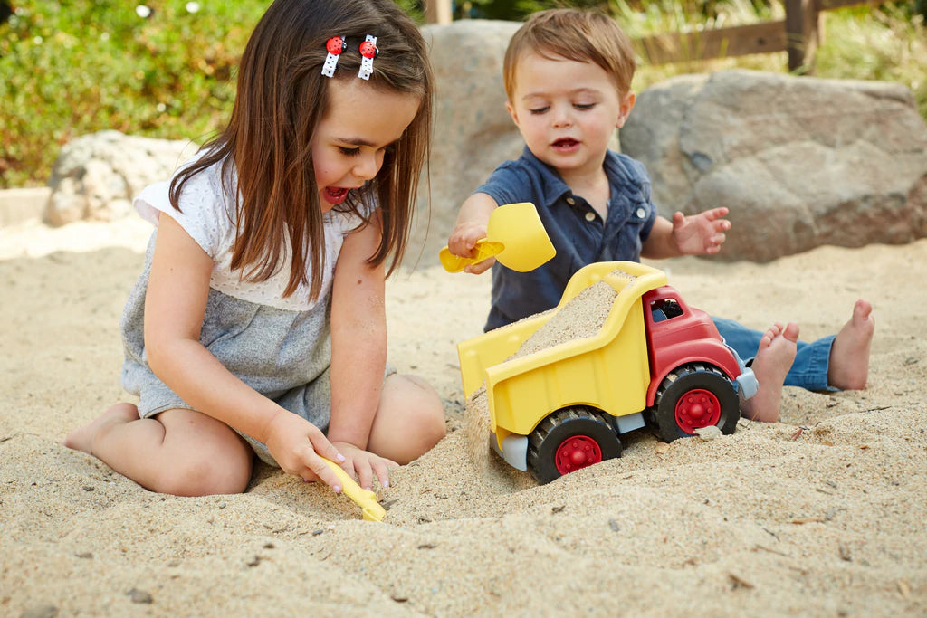 Children playing with the dump truck toy